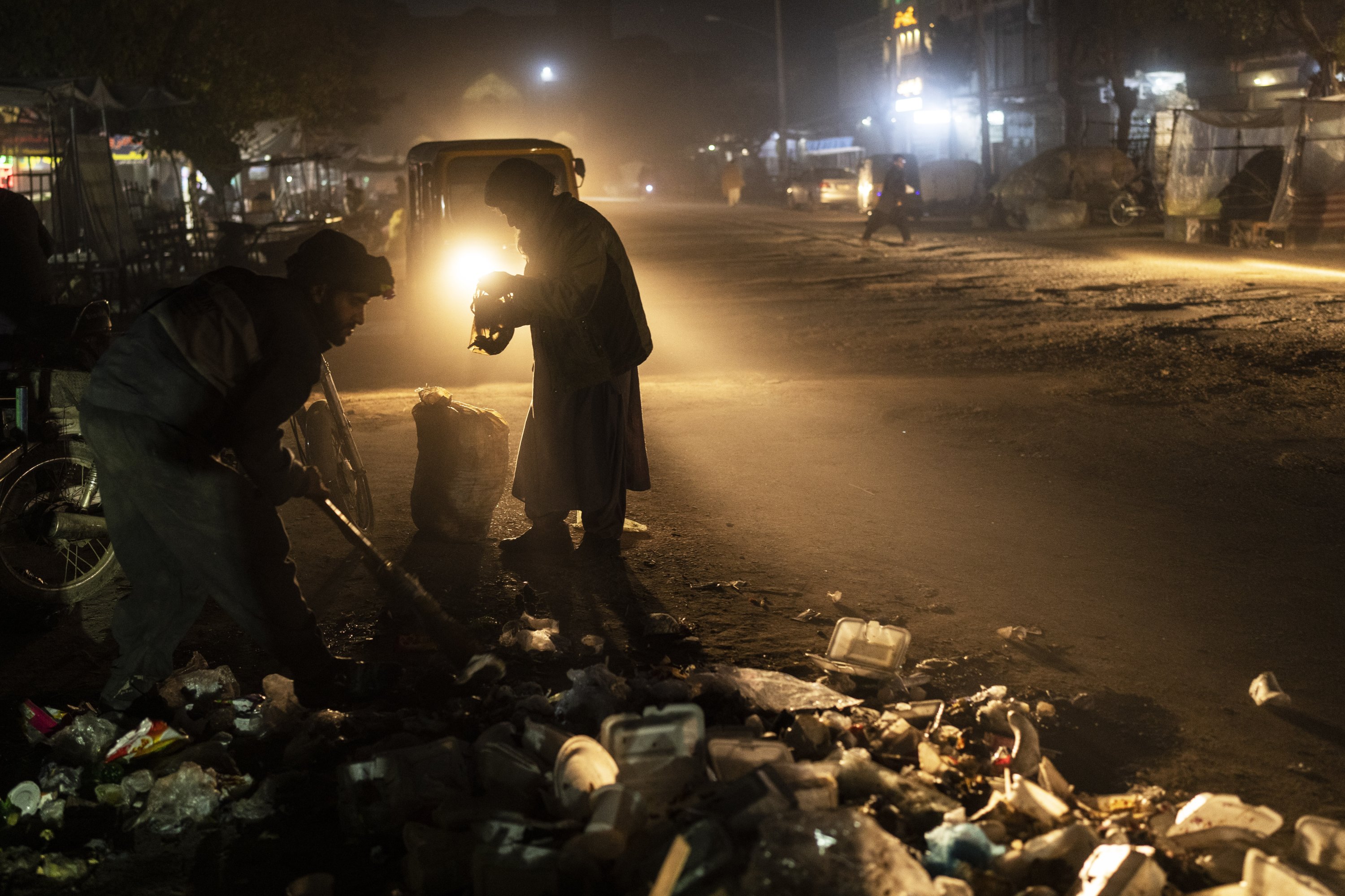 An Afghan man collects scraps of alluminium and plastic, in Herat, Afghanistan, Nov. 22, 2021. (AP Photo)