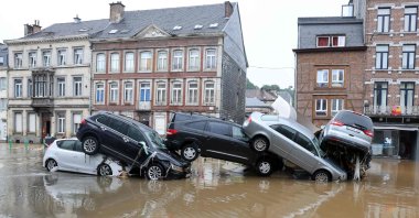 Cars piled up by the water at a roundabout in the Belgian city of Verviers after heavy rains and floods lashed Belgium, July 15, 2021. (AFP Photo)