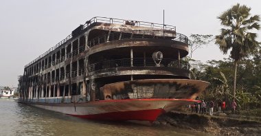 The burnt-out ferry is seen anchored along a coast a day after it caught fire, killing at least 37 people in Jhalkathi, 250 kilometers (160 miles) south of Dhaka, Dec. 24, 2021. (AFP Photo)