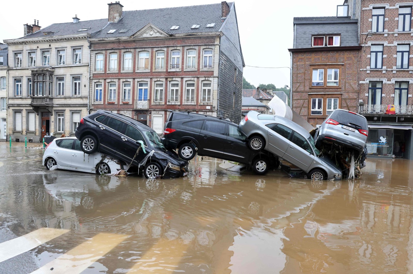 Cars piled up by the water at a roundabout in the Belgian city of Verviers after heavy rains and floods lashed Belgium, July 15, 2021. (AFP Photo)