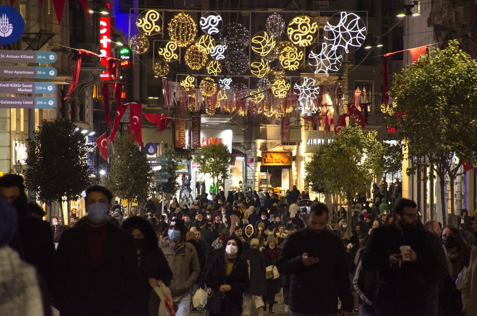 People walk on Istiklal Avenue, in Istanbul, Turkey, Dec. 24, 2021. (AA PHOTO) 