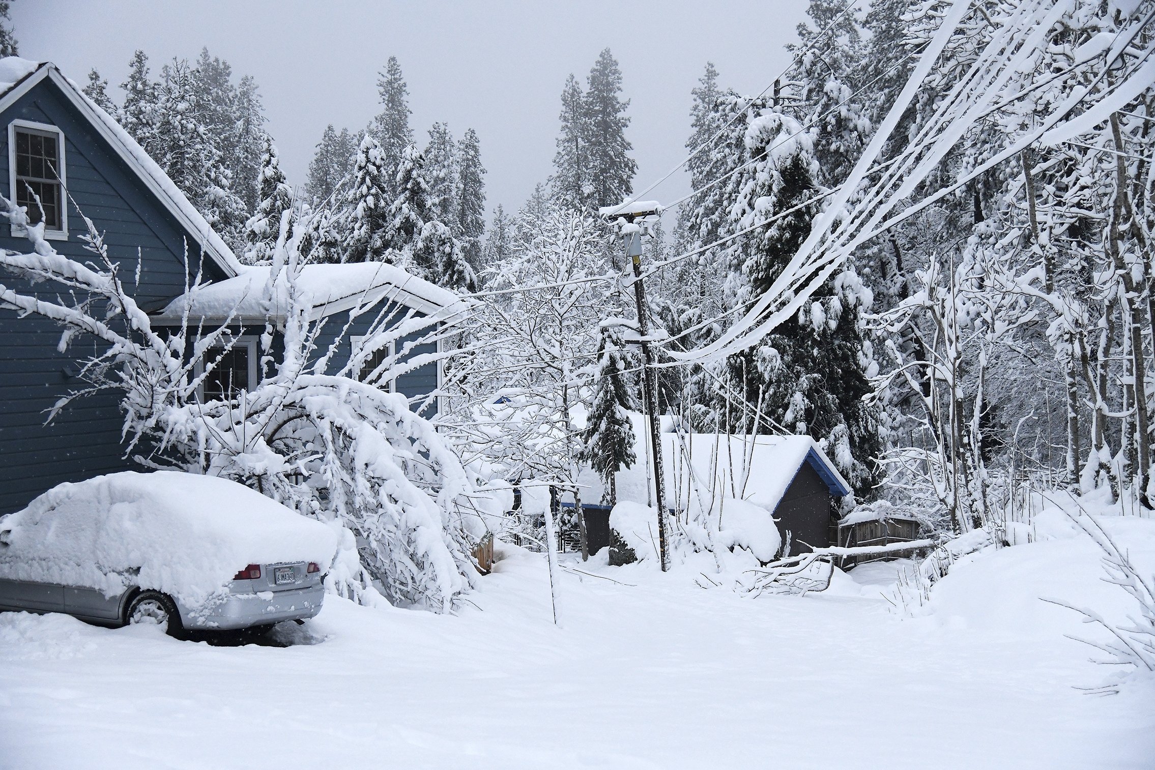 Spring Street in Nevada City, California was socked in with snow and downed tree limbs, U.S., Dec. 27, 2021. (AP Photo)