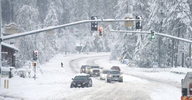 A vehicle is stuck in the snow along Brunswick Road and Sutton Way, in Grass Valley, California, U.S., Dec. 27, 2021. (AP Photo)