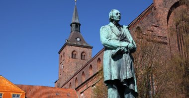 Sculpture of world famous Danish fairy tale writer and poet Hans Christian Andersen in front of the Sankt Knuds church in his hometown of Odense, Denmark. (Getty Images)