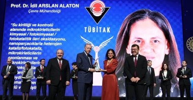 President Recep Tayyip Erdoğan hands out an award to Professor İdil Arslan Alaton at the ceremony in the capital Ankara, Turkey, Dec. 28, 2021. (AA PHOTO)