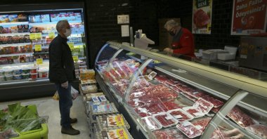 A man buys food at a supermarket in the capital Ankara, Turkey, Dec. 3 2021. (AP Photo)