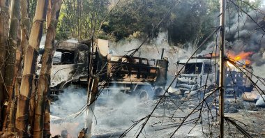 Smoke and flames billow from vehicles in Hpruso township, Kayah state, Myanmar, Dec. 24, 2021. (Karenni Nationalities Defense Force via AP)