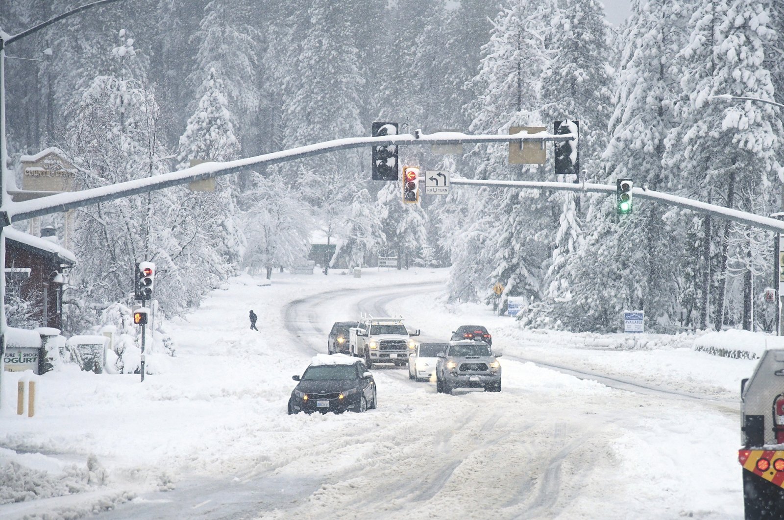 A vehicle is stuck in the snow along Brunswick Road and Sutton Way, in Grass Valley, California, U.S., Dec. 27, 2021. (AP Photo)