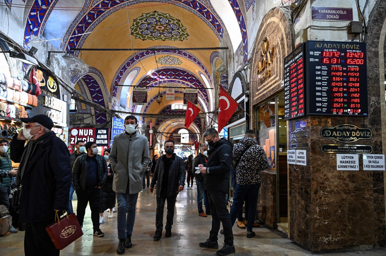 Customers wait in front of a currency exchange agency near the Grand Bazaar in Istanbul, Turkey, Dec. 2, 2021. (AFP Photo)