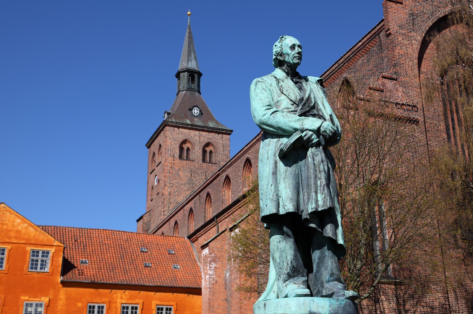 Sculpture of world famous Danish fairy tale writer and poet Hans Christian Andersen in front of the Sankt Knuds church in his hometown of Odense, Denmark. (Getty Images)