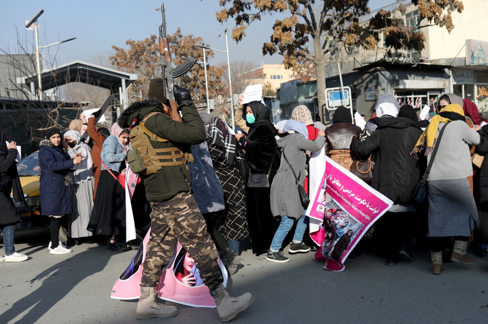 A member of the Taliban fires in the air to disperse a group of Afghan women during a rally to protest against the Taliban&#039;s restrictions on women in Kabul, Afghanistan, Dec. 28, 2021. (Reuters Photo)