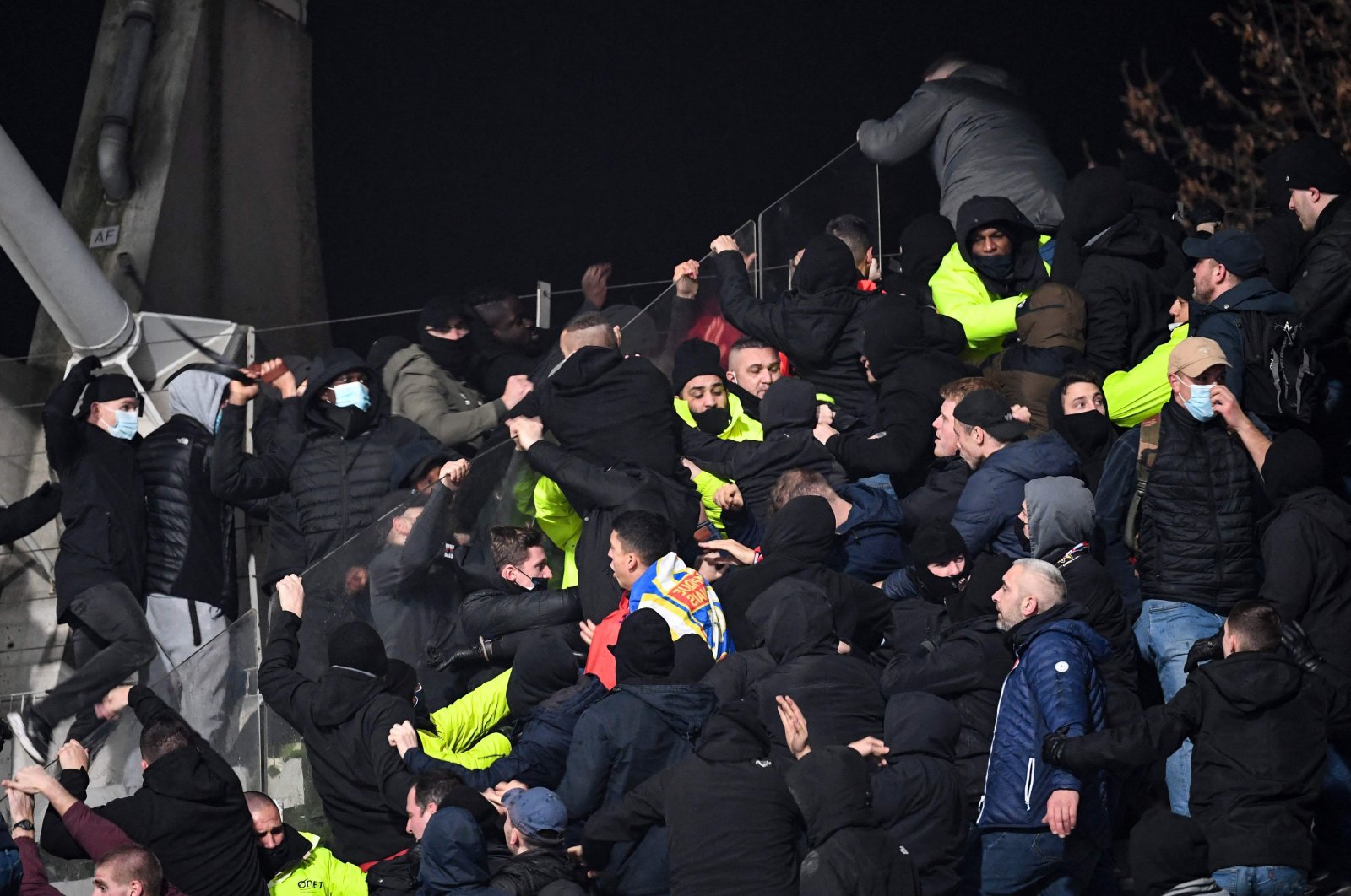 Security staff intervenes as supporters clash during a French Cup match between Paris FC and Olympique Lyonnais, Paris, France, Dec. 17, 2021. (AFP Photo)