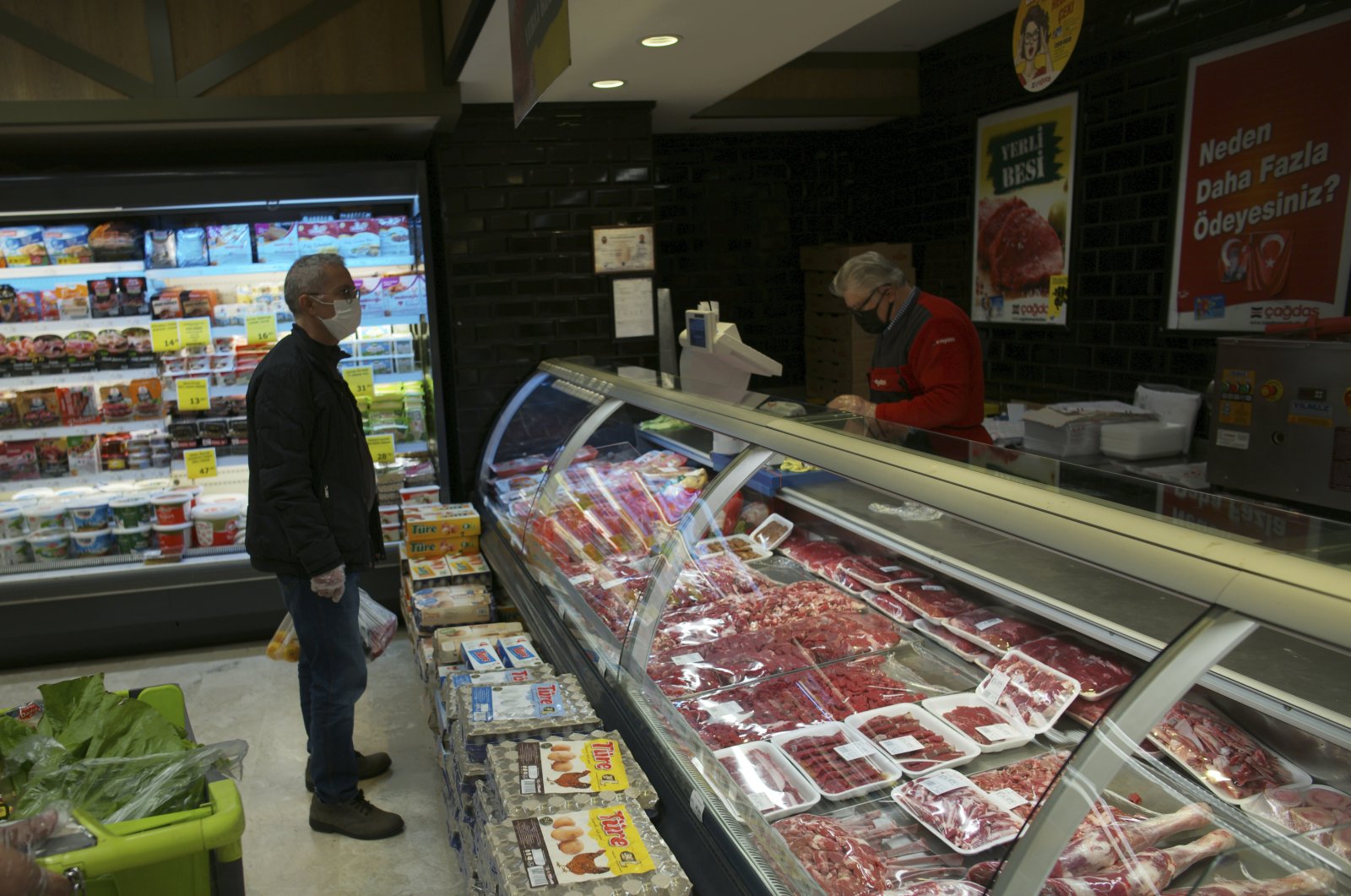 A man buys food at a supermarket in the capital Ankara, Turkey, Dec. 3 2021. (AP Photo)