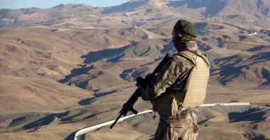 A Turkish soldier is seen standing guard near the border wall on the Turkey-Iran border, Van, eastern Turkey, Dec. 7, 2021. (IHA Photo)