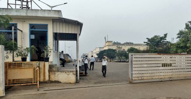 Private security guards stand at the entrance of a closed plant of Foxconn, which makes iPhones for Apple Inc., near Chennai, India, Dec. 22, 2021. (Reuters Photo)