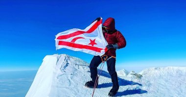 Turkish Republic of Northern Cyprus (TRNC) citizen Birkan Uzun waves the Turkish Cypriot flag from atop Mt. Vinson, the highest peak in Antarctica. (AA)