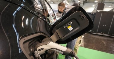The new fully electric car BMW iX is charged at the Motor Show in Essen, Germany, Dec. 2, 2021. (AP Photo)