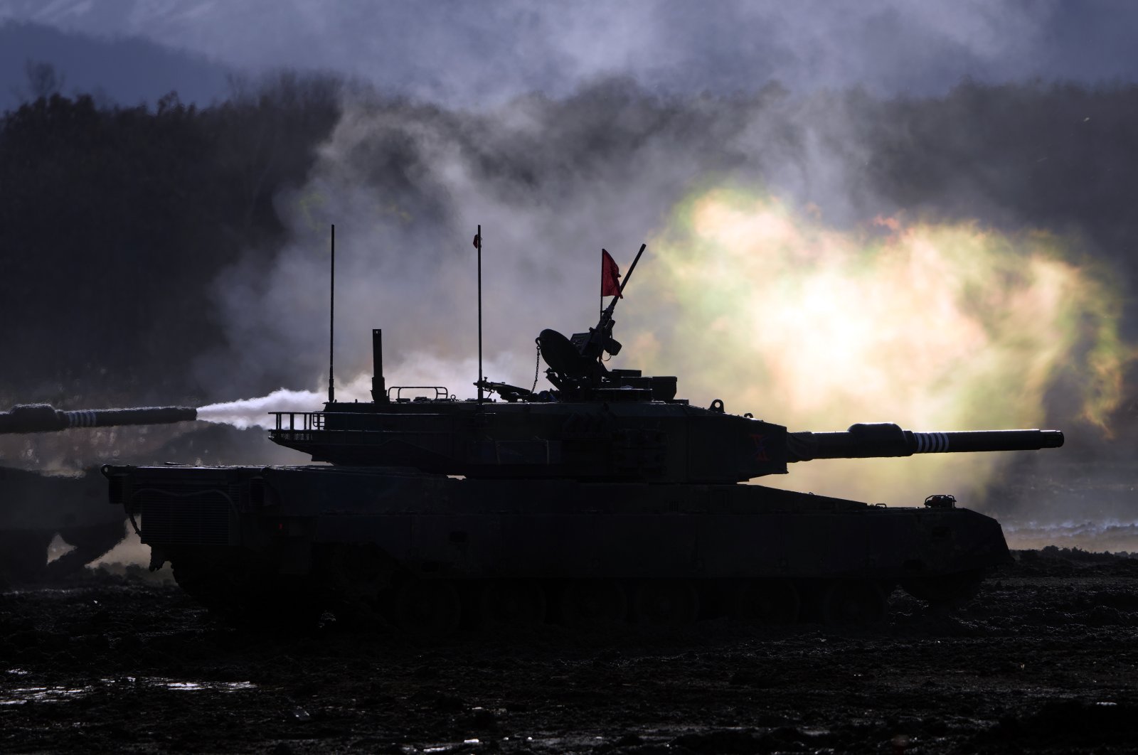 Japanese military Type 90 tanks fire at a target with live ammunition during an annual drill at Minami Eniwa Camp in Eniwa on the northern Japanese island of Hokkaido, Dec. 6, 2021. (AP Photo)
