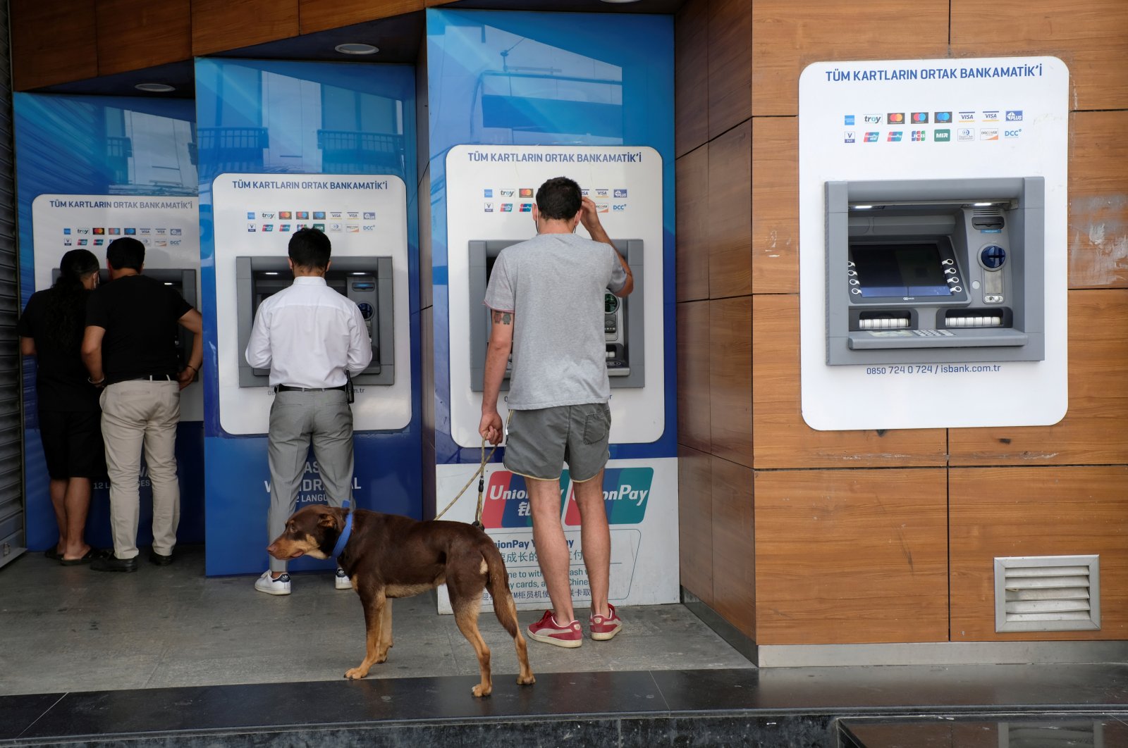 People withdraw money from ATM machines at the main shopping and pedestrian street of Istiklal in central Istanbul, Turkey, July 25, 2020. (Reuters Photo)