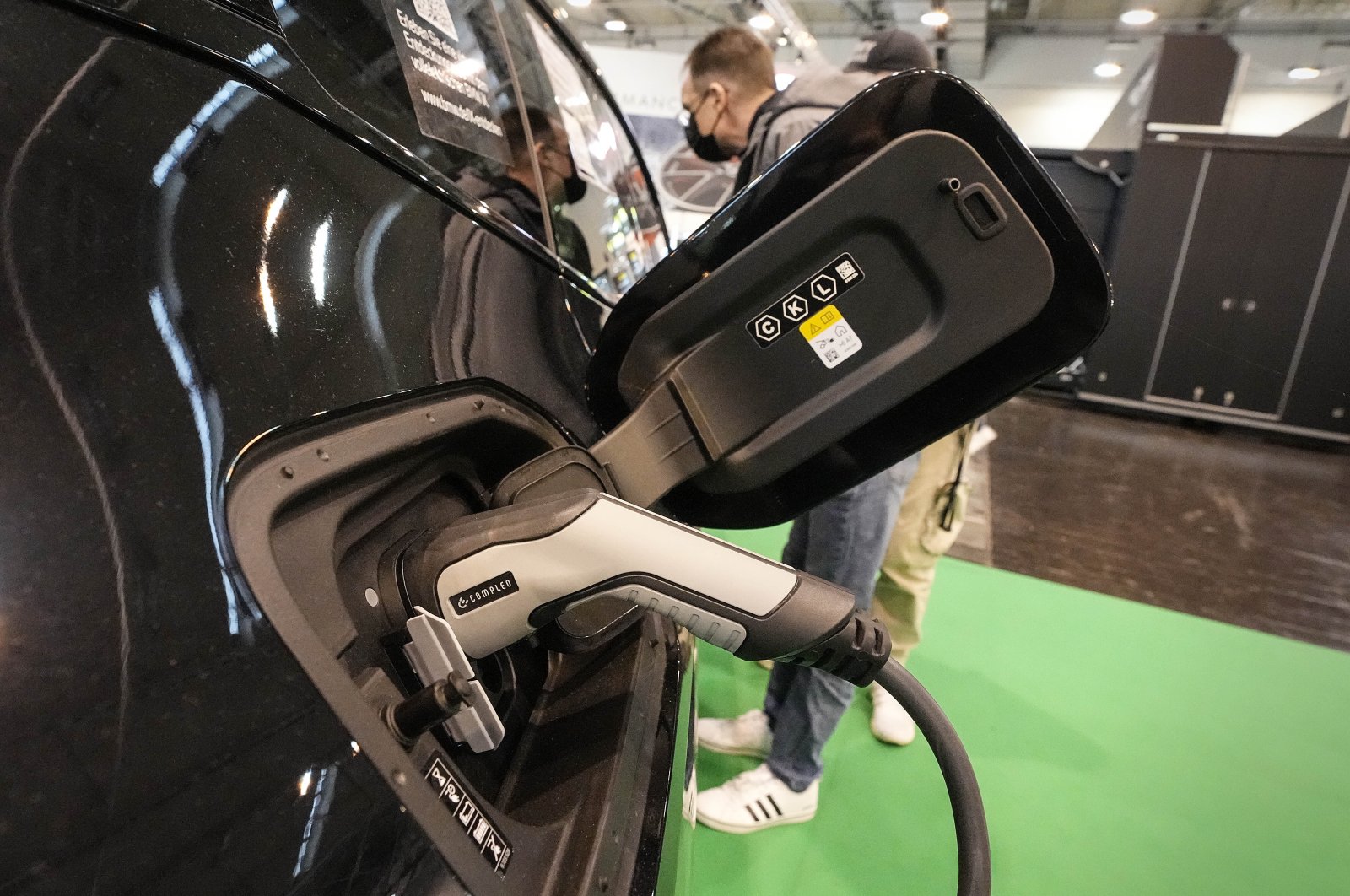 The new fully electric car BMW iX is charged at the Motor Show in Essen, Germany, Dec. 2, 2021. (AP Photo)