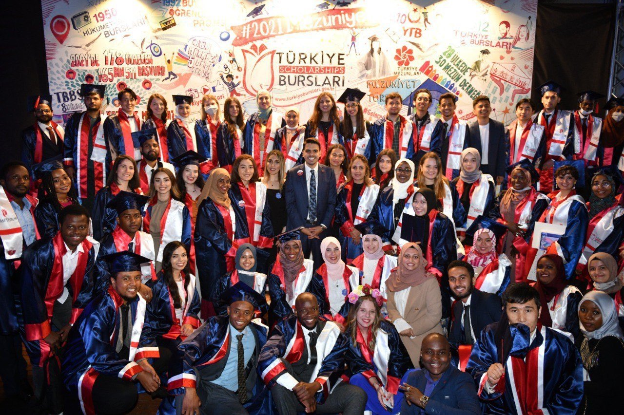 Graduates of Turkey Scholarships pose with YTB President Abdullah Eren (C) during a ceremony in the capital Ankara, Turkey, July 8, 2021. (Courtesy of YTB)