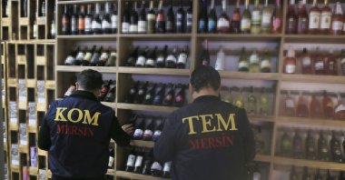 Police officers check drinks at a shop during an inspection against bootleg alcohol, in Mersin, southern Turkey, Dec. 29, 2021. (AA Photo)