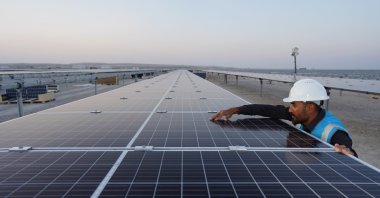 An employee works next to the solar power panels in the Karapınar Solar Power Plant, Konya, central Turkey, Sept. 29, 2020. (IHA Photo)