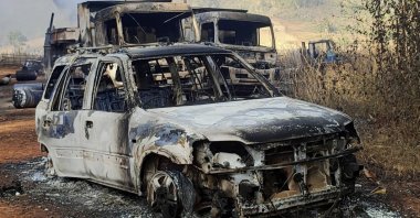 In this photo provided by the Karenni Nationalities Defense Force (KNDF), vehicles smolder in Hpruso township, Kayah state, Myanmar, Friday, Dec. 24, 2021. (AP Photo)