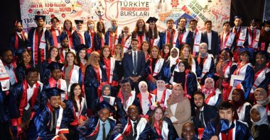 Graduates of Turkey Scholarships pose with YTB President Abdullah Eren (C) during a ceremony in the capital Ankara, Turkey, July 8, 2021. (Courtesy of YTB)