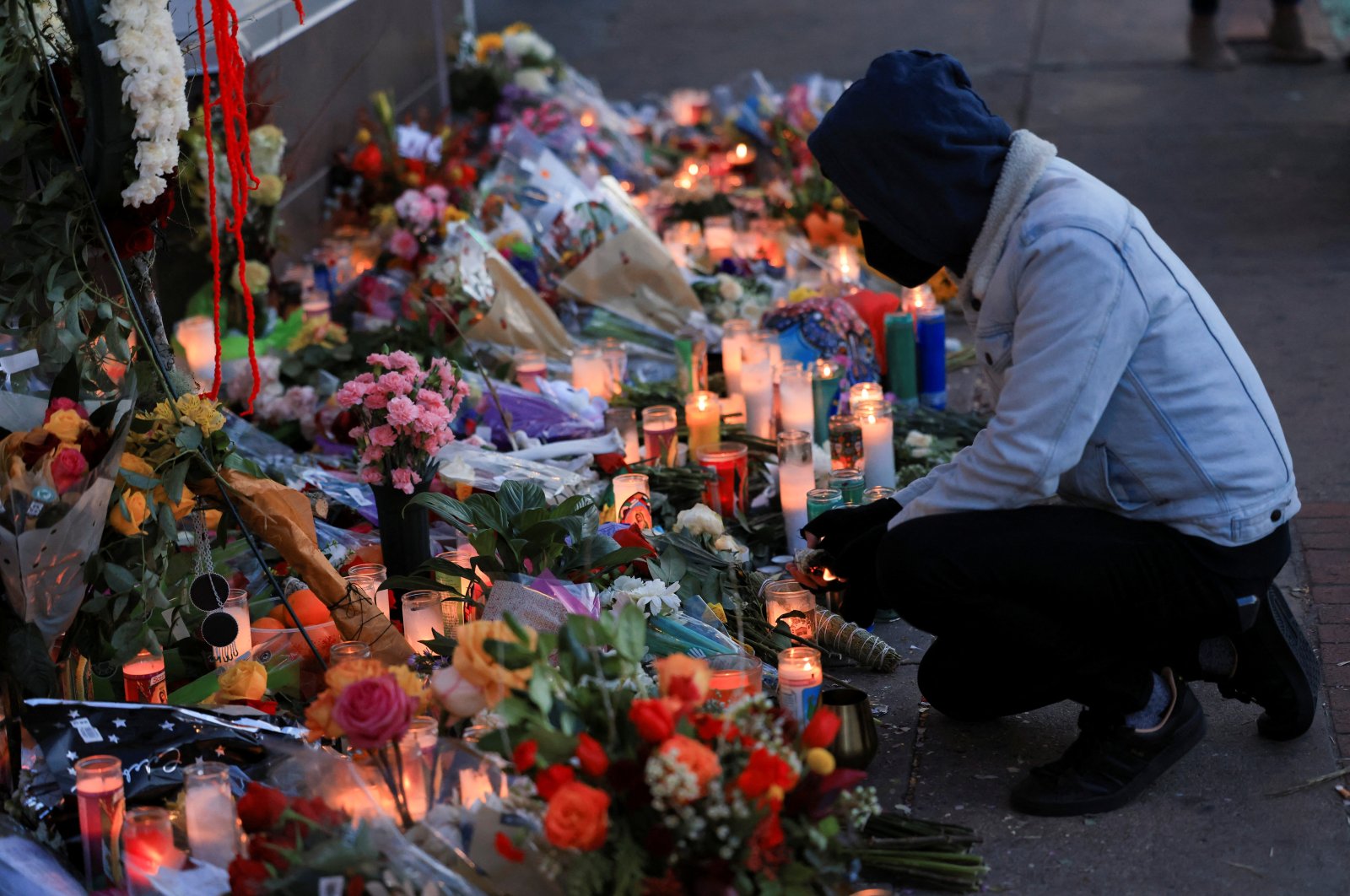 People create a memorial of candles and flowers outside the tattoo shop where owner Alicia Cardenas was killed during a shooting spree in Denver, Colorado, U.S., Dec. 29, 2021. (Reuters Photo)