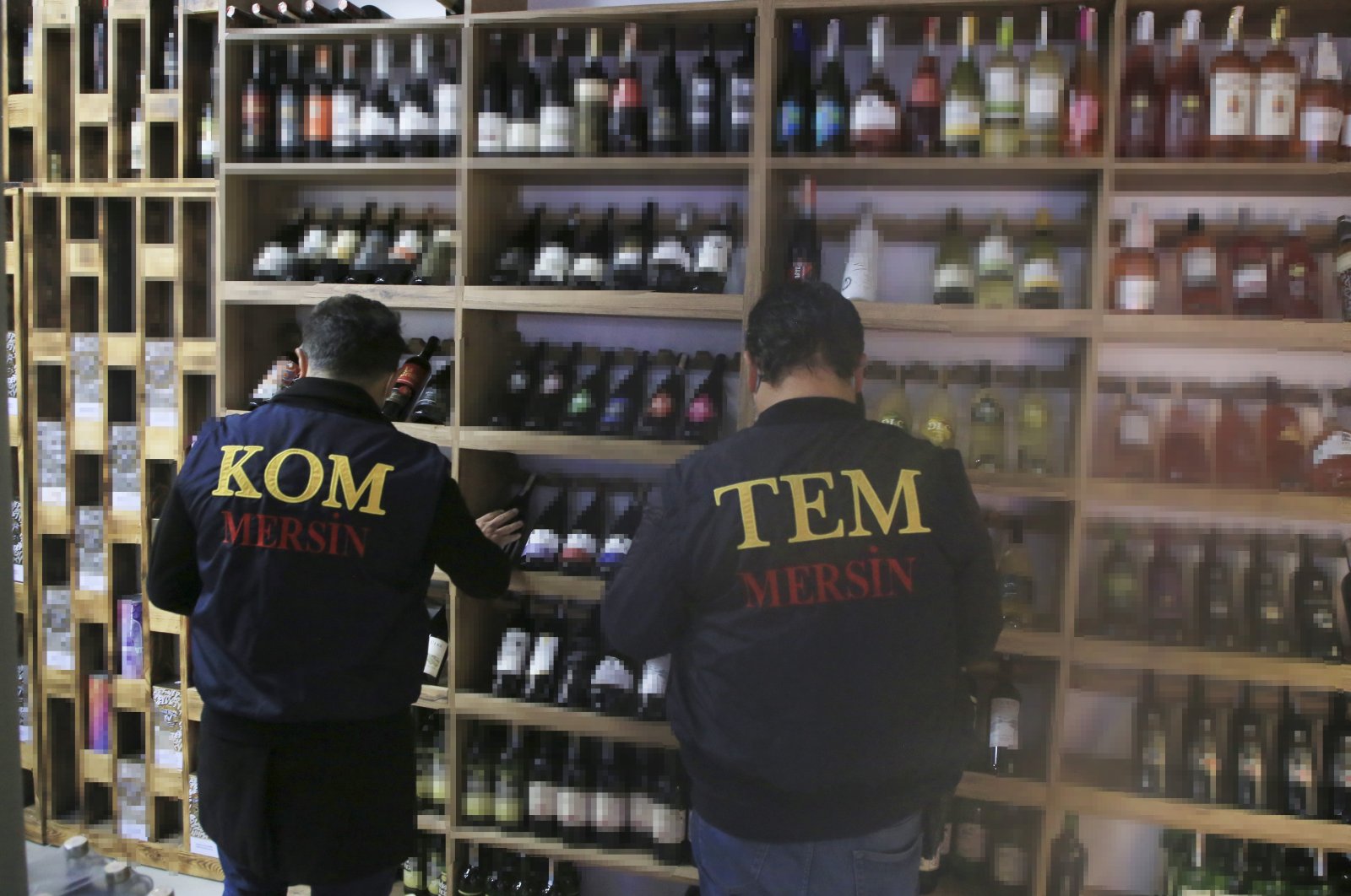 Police officers check drinks at a shop during an inspection against bootleg alcohol, in Mersin, southern Turkey, Dec. 29, 2021. (AA Photo)