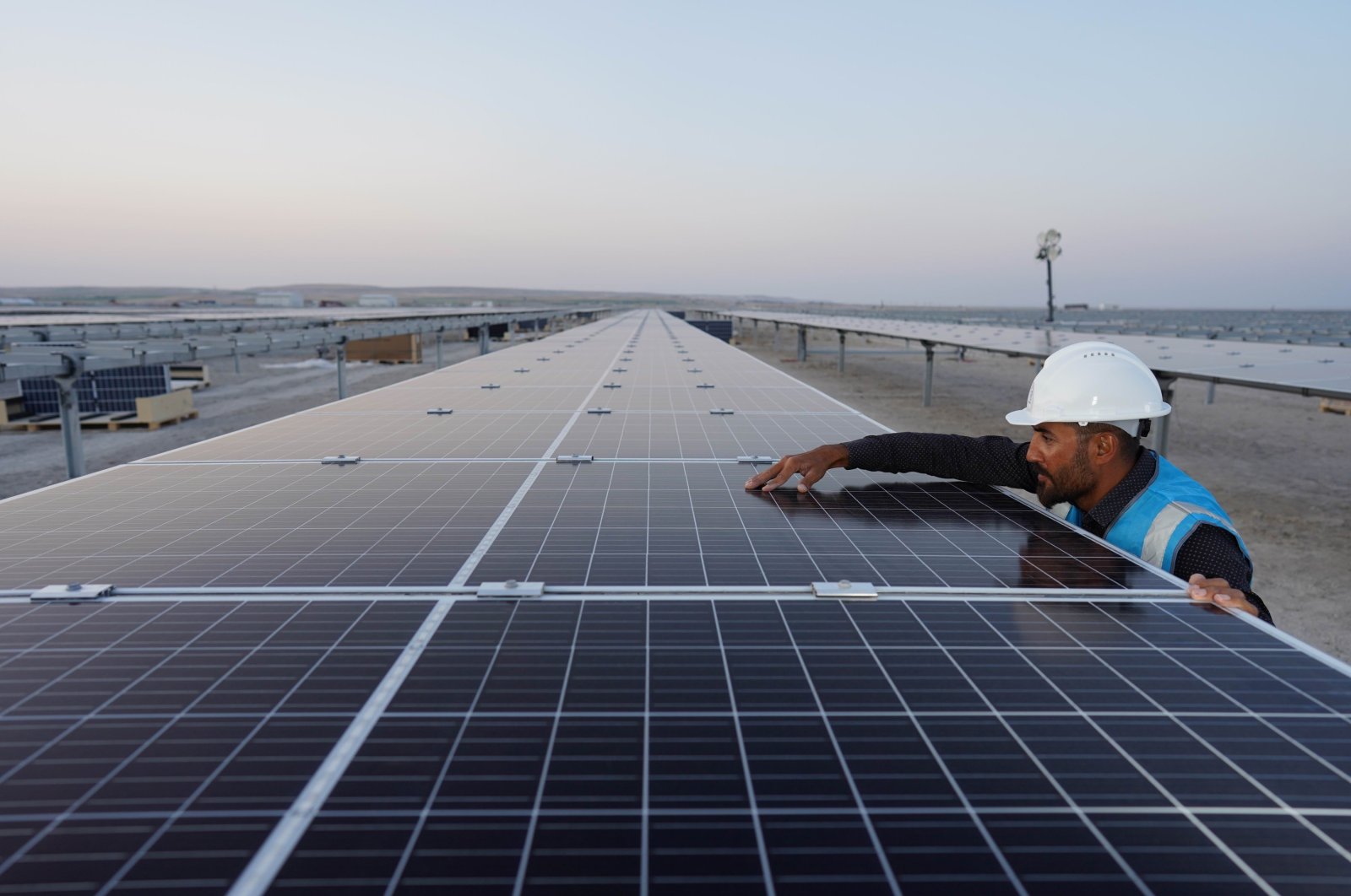 An employee works next to the solar power panels in the Karapınar Solar Power Plant, Konya, central Turkey, Sept. 29, 2020. (IHA Photo)
