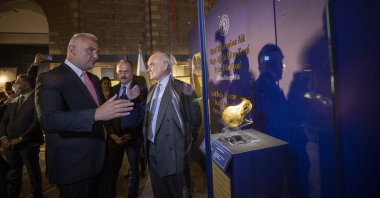Culture and Tourism Minister Mehmet Nuri Ersoy (L) stands next to a 4,250-year-old ewer retrieved from the United Kingdom at the Museum of Anatolian Civilizations in the capital Ankara, Turkey, Oct. 26, 2021. (AA PHOTO)