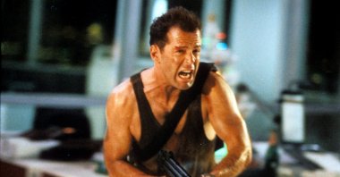 Bruce Willis runs with an automatic weapon in a scene from the film 'Die Hard,' 1988. (Getty Images)