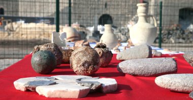Newly found artifacts are displayed on a table on site at the historic 9,000-year-old Amida Mound, Dec. 31, 2021. (AA Photo)