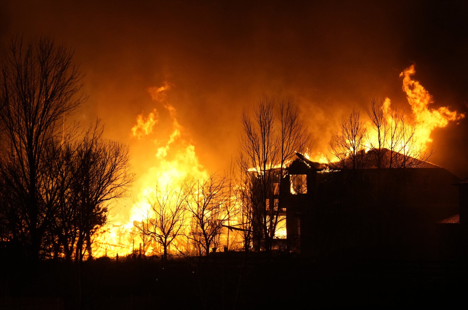 Homes burn as wildfires rip through a development, Dec. 30, 2021, in Superior, Colo. (AP Photo)