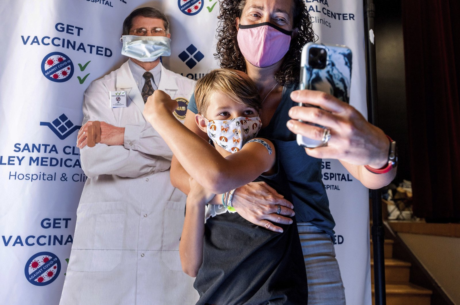 Finn Washburn, 9, shows his vaccination site as his mother, Kate Elsley, takes a photo shortly after he received a Pfizer COVID-19 vaccine in San Jose, California, U.S., on Nov. 3, 2021. (AP Photo)