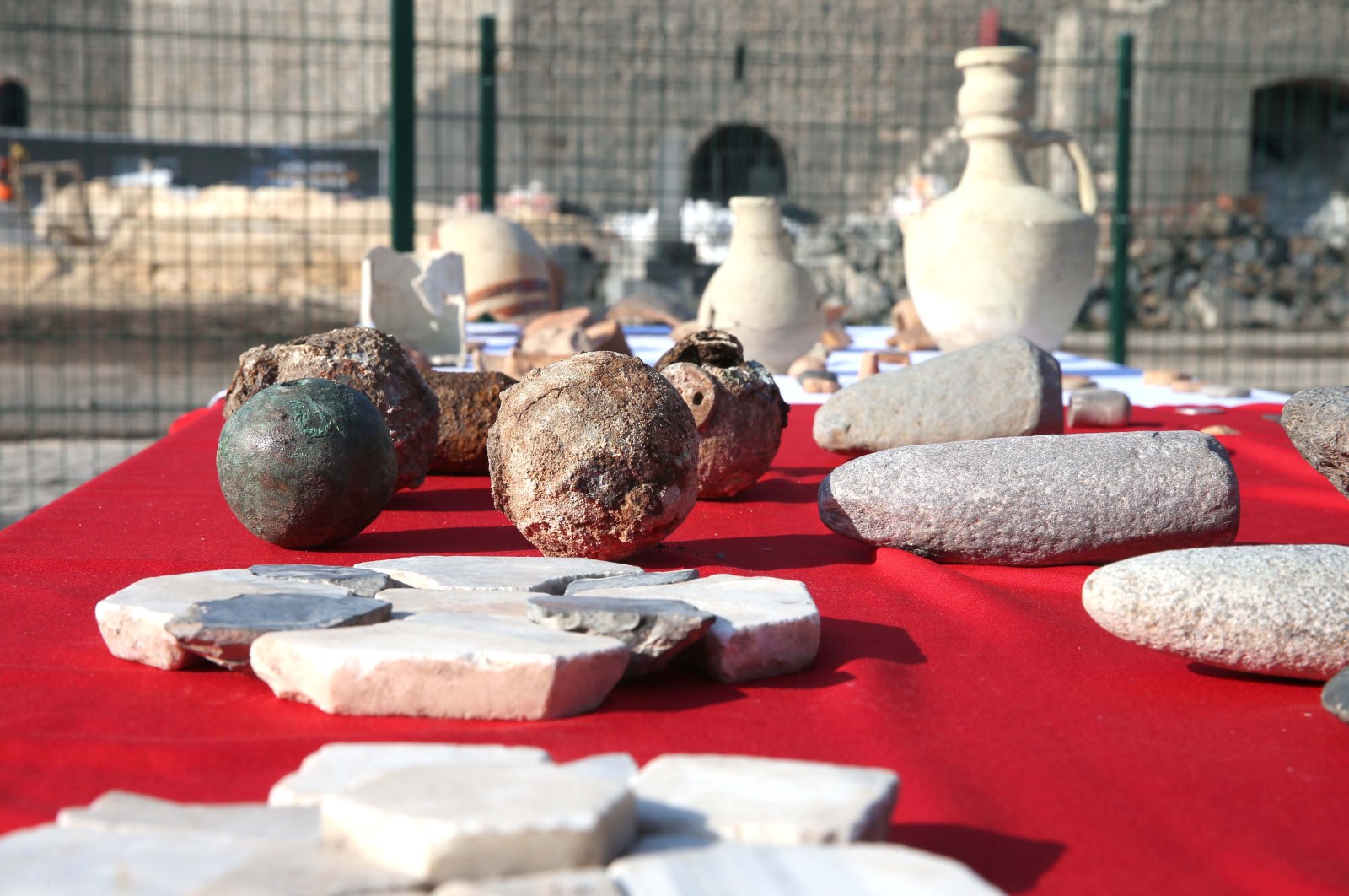 Newly found artifacts are displayed on a table on site at the historic 9,000-year-old Amida Mound, Dec. 31, 2021. (AA Photo)
