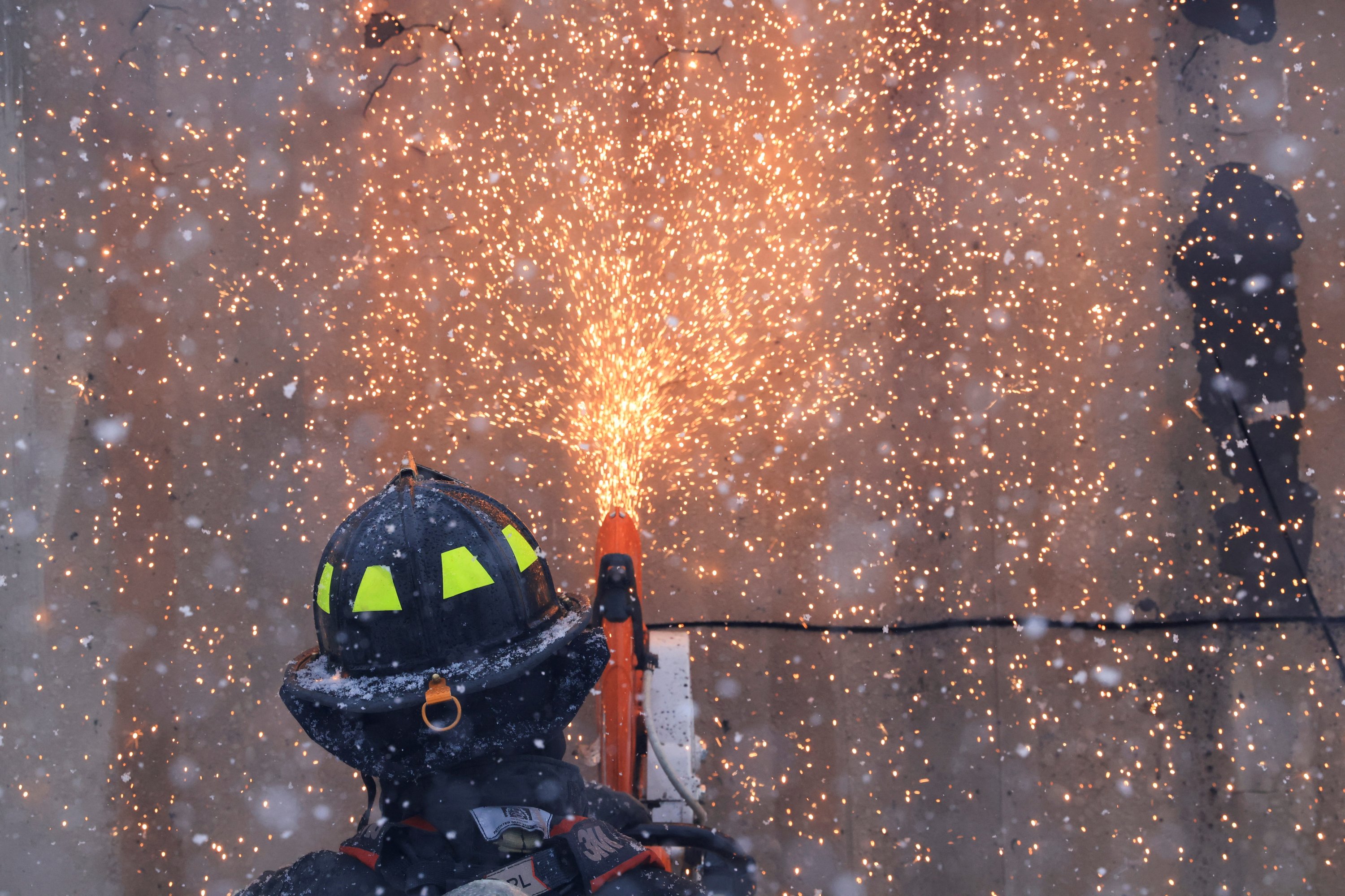 A firefighter cuts holes into a burning shipping container to spray water inside from different angles, a day after evacuation orders, in Louisville, Colorado, U.S., Dec. 31, 2021. (Reuters Photo)