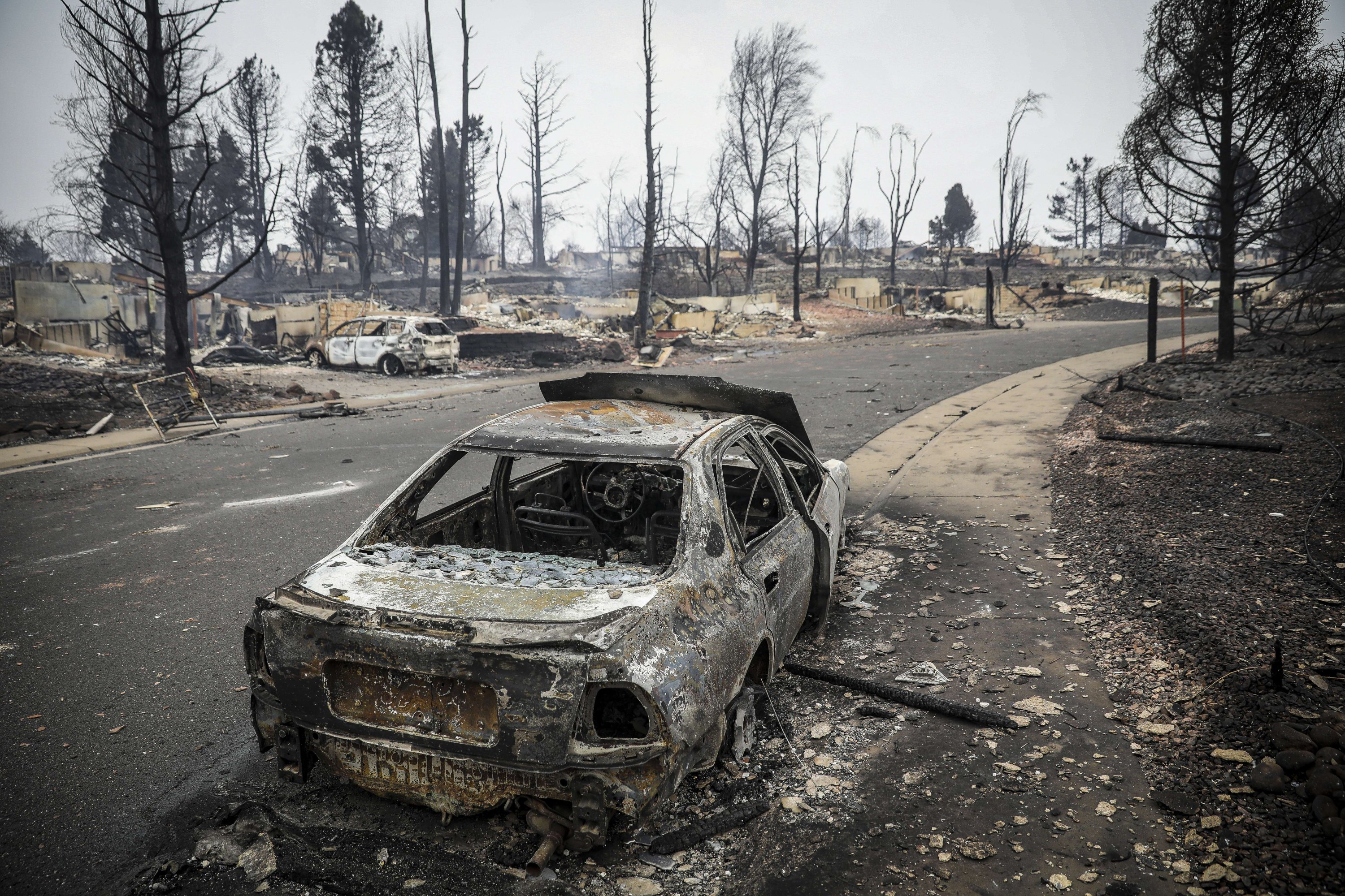 The remains of a burnt out car stands amidst the remains of a neighborhood in the aftermath of the Marshall Fire in Louisville, Colorado, Dec. 31, 2021. (Getty Images/AFP Photo)