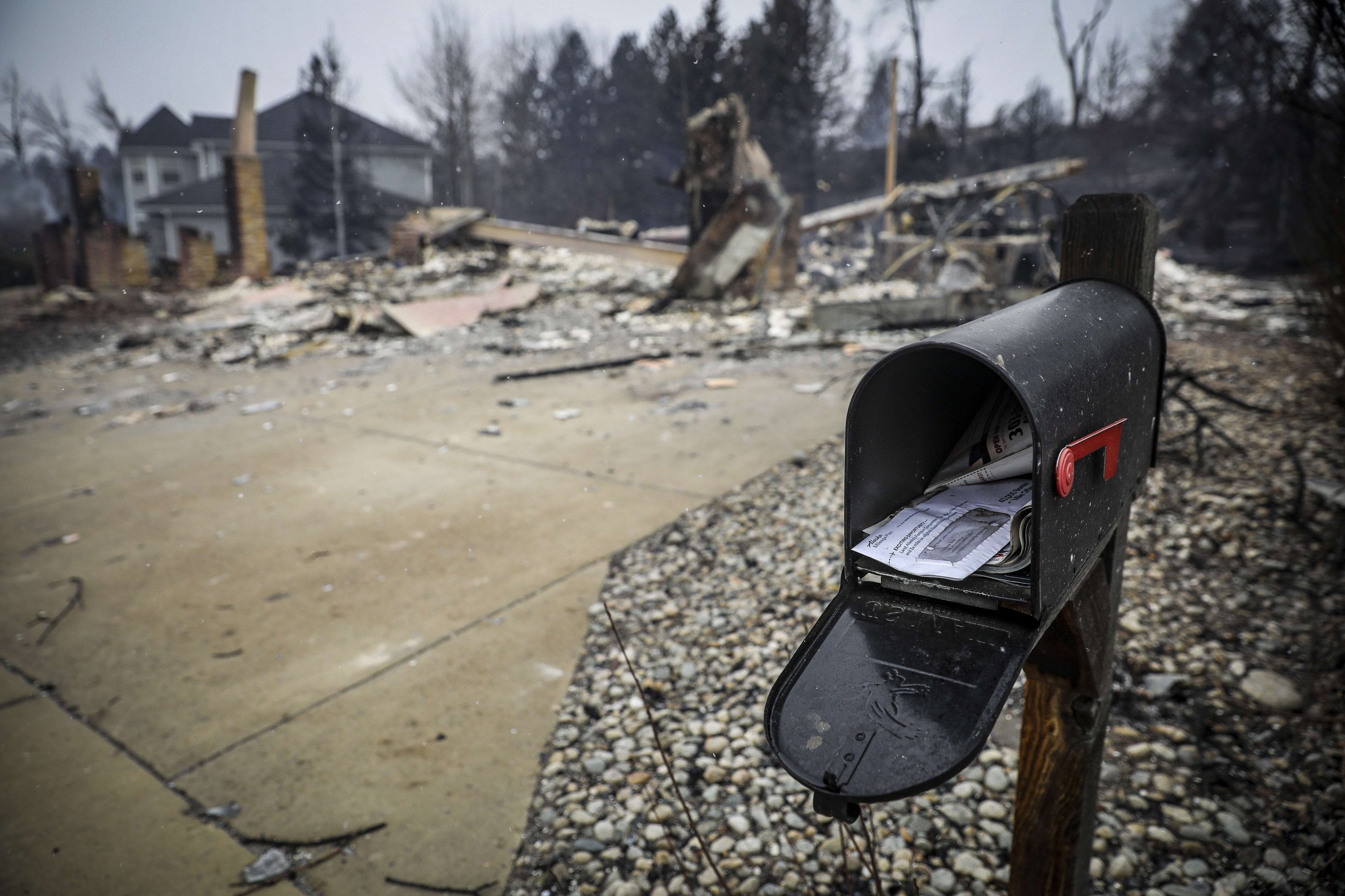 Uncollected mail sits in a mailbox in front of the remains of a home in the aftermath of the Marshall Fire in Louisville, Colorado, Dec. 31, 2021. (Getty Images/AFP Photo)