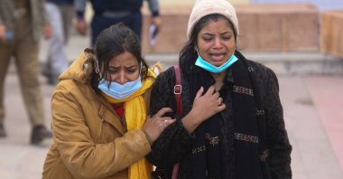 Relatives of a victim who died in a stampede at the Vaishno Devi shrine, one of the country's most revered Hindu sites, weep outside a mortuary in Katra, India, Jan. 1, 2022. (AFP Photo)