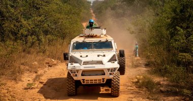 A United Nations armored personnel carrier patrols on a supposedly safe road, avoiding roads with possible explosive devices on them, in Paoua, Central African Republic, on Dec. 5, 2021. (Photo by Barbara DEBOUT / AFP)
