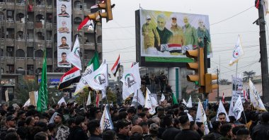 Members and supporters of Iraq&#039;s al-Hashed al-Shaabi ex-paramilitary alliance take part in a demonstration and a symbolic funeral for slain top Iranian commander Qasem Soleimani and slain Iraqi commander Abu Mahdi al-Muhandis in Baghdad, Iraq, Jan. 1, 2022. (AFP Photo)