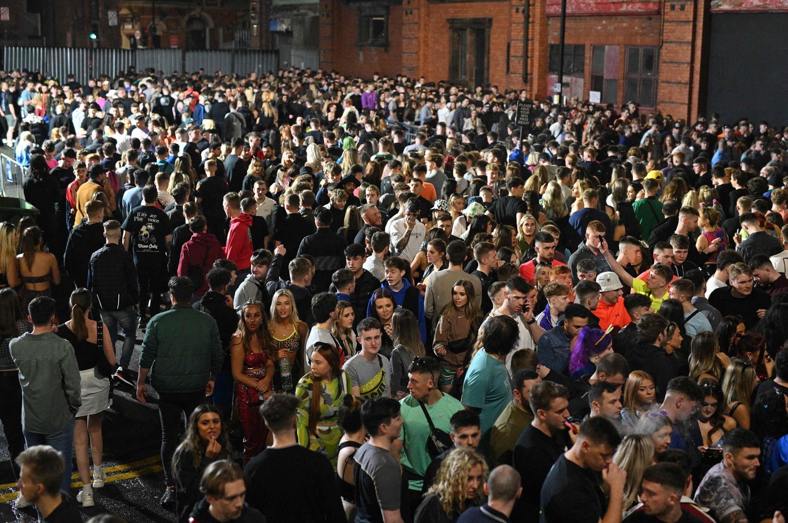 Revellers queue to enter Depot Mayfield, a 10,000 capacity club, on New Year&#039;s Eve, in Manchester, north-west England, Dec. 31, 2021. (AFP Photo)