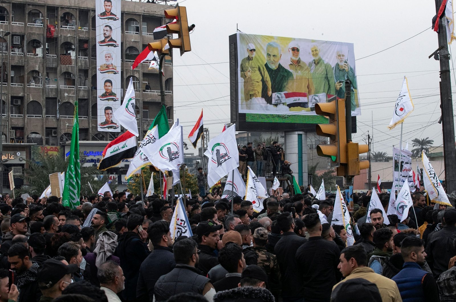 Members and supporters of Iraq&#039;s al-Hashed al-Shaabi ex-paramilitary alliance take part in a demonstration and a symbolic funeral for slain top Iranian commander Qasem Soleimani and slain Iraqi commander Abu Mahdi al-Muhandis in Baghdad, Iraq, Jan. 1, 2022. (AFP Photo)