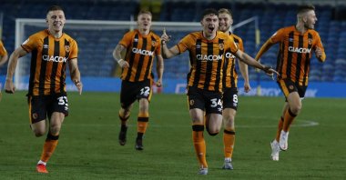 Hull City players run to celebrate after their winning penalty following the penalty shootout during an English League Cup match against Leeds United, Leeds, England, Sept. 16, 2020. (AP Photo)