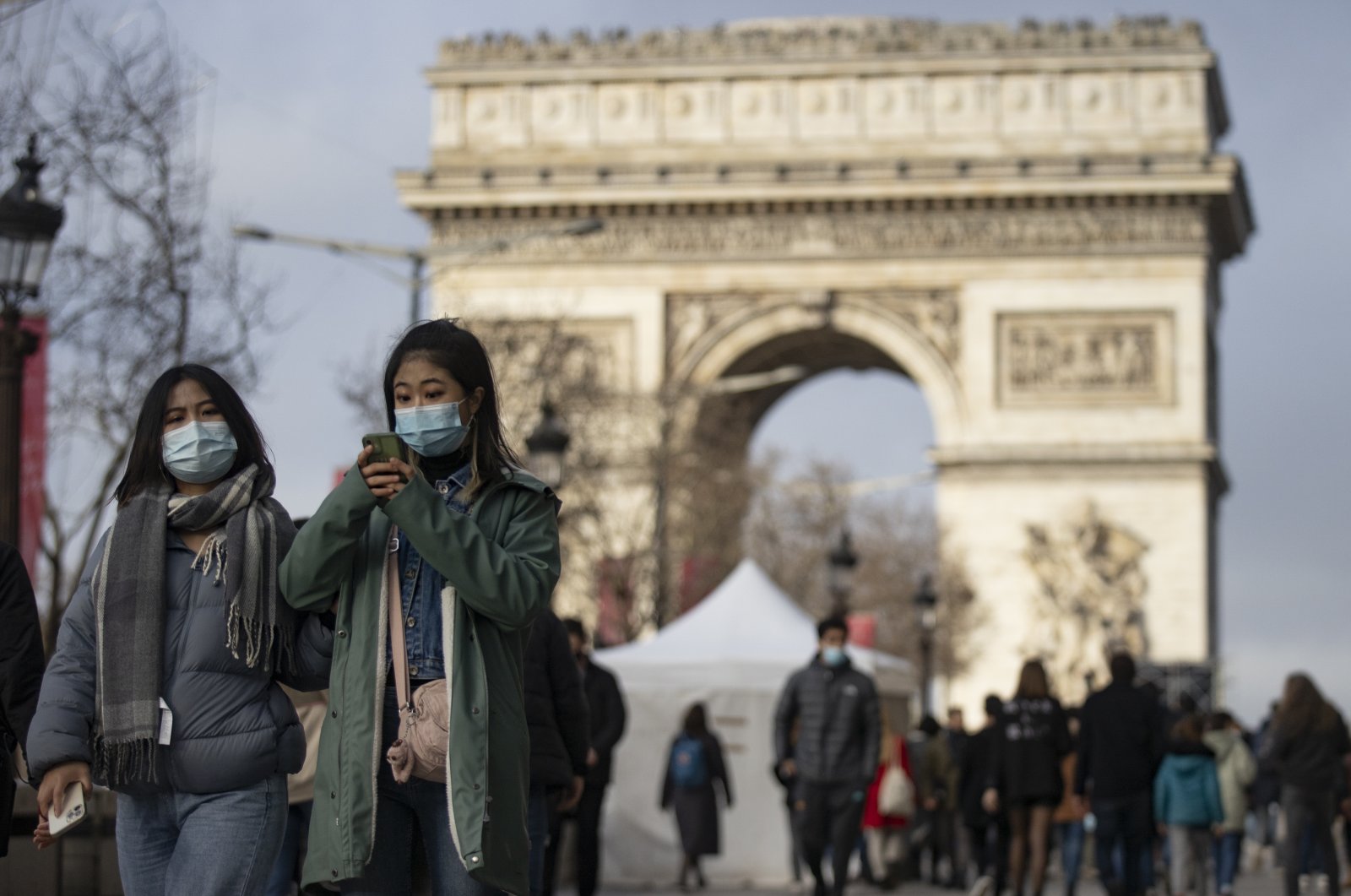 Pedestrians wearing face masks walk on the Champs-Elysees in central Paris, France, Dec. 30, 2021. (EPA Photo)