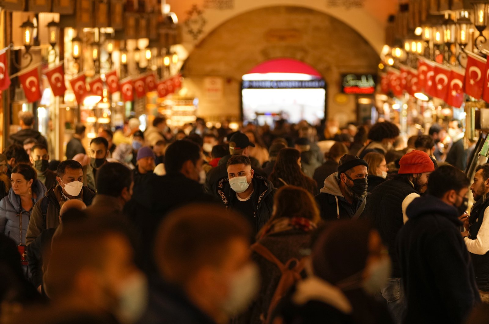 Pedestrians, some wearing protective face masks, walk in the Spice Bazaar, in Istanbul, Turkey, Dec. 31, 2021. (AP PHOTO)