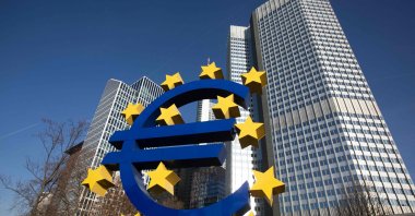 A sculpture depicting the Euro currency symbol by German artist Ottmar Hِrl is seen in front of the former European Central Bank (ECB) headquarters building in Frankfurt am Main, Germany, Dec. 22, 2021. (AFP Photo)